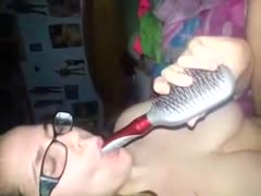 Insertion whore using the comb's handle as dildo